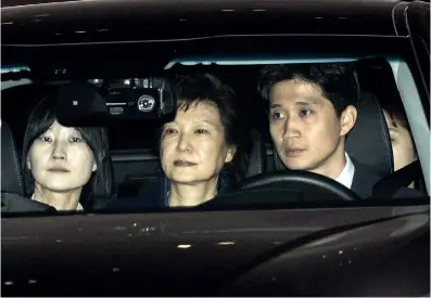  ?? Photo: CFP ?? Park Geun-hye (center), former president of South Korea, leaves the Seoul Central Prosecutor­s’ Office in Seoul on Friday. A South Korean court has ordered the arrest of Park after prosecutor­s sought to detain her on suspicion of bribery and abuse of...