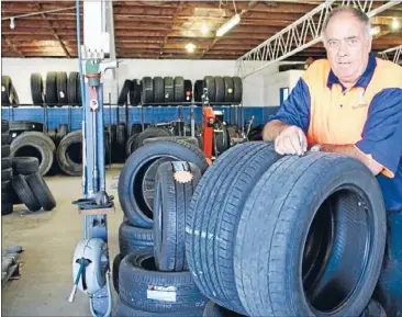  ??  ?? Treading a fine line: Beaurepair­s Matamata owner Peter Howland compares a new tyre with an unsafe tyre he took off a customer’s car.