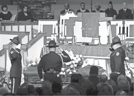  ?? LARRY MCCORMACK/THE TENNESSEAN ?? Officers salute the casket during the funeral of Debra Johnson on Friday at The Temple Church in Nashville. Johnson, a Tennessee Department of Correction administra­tor, was slain Aug. 7.