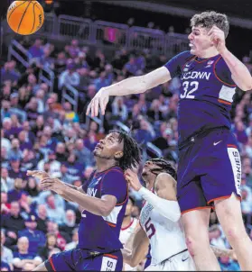  ?? ?? Uconn center Donovan Clingan rejects a shot attempt by Gonzaga guard Hunter Sallis with teammate Tristen Newton trailing.