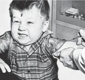  ?? ASSOCIATED PRESS ?? Jeffery Trzeciak, 3, grimaces as a doctor prepares to give him a polio vaccine inoculatio­n on Feb. 23, 1957.