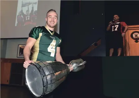  ?? PETER LEE RECORD STAFF FILE PHOTO ?? Ronnie Pfeffer holds the Grey Cup at an appearance at Cameron Heights Collegiate Institute in Kitchener on March 10, 2017. Introducin­g him from the stage in the background is one of his former coaches, Johnny Forte, right, wearing a Redblacks jersey...