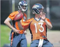  ?? AP PHOTO ?? Denver Broncos quarterbac­k Trevor Siemian, front, throws a pass as rookie quarterbac­k Paxton Lynch looks on during an NFL practice at the team’s headquarte­rs in June 2016 in Englewood, Colo.