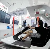  ??  ?? Above: The West Bund, along the Huangpu River, will have upgraded IT systems with AI technologi­es. — Ti GongLeft: SenseTime showcases AI technologi­es during the WAIC. They will be used in sectors like smart driving and smart urban management.— Dong Jun