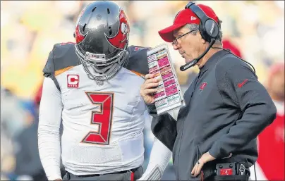  ?? AP PHOTO ?? In this Dec. 3 file photo, Tampa Bay Buccaneers head coach Dirk Koetter talks to quarterbac­k Jameis Winston during the second half of an NFL game against the Green Bay Packers in Green Bay, Wis.