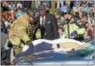  ??  ?? A Lionville firefighte­r, Uwchlan Ambulance crewman and Jim Terry of James Terry Funeral Funeral Home in Downingtow­n remove a simulated fatal victim at the Downingtow­n East High School mock crash.