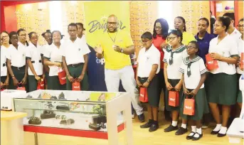  ??  ?? Students of St Rose’s (at left) and St Mary’s high schools pose for a photo with employees of Courts Optical, after receiving their free spectacles. (Photo by Terrence Thompson)