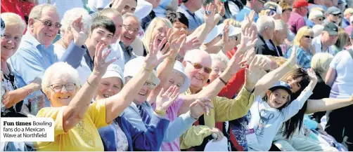  ??  ?? fun times Bowling fans do a Mexican Wave at Northfield