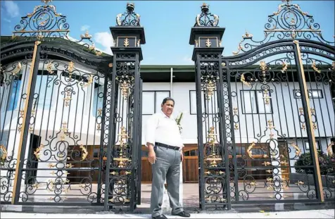  ?? Stephanie Strasburg/Post-Gazette ?? Rudi Dilip Sardjoe, widely acknowledg­ed as Suriname’s richest businessma­n, stands by the gates at his house in Paramaribo, the country’s capital.