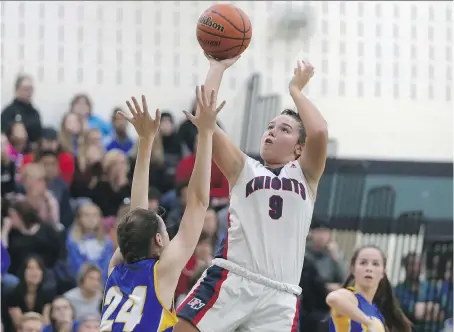  ?? JASON KRYK ?? Holy Names Knights’ Aessandra Caccavo shoots over St. Anne’s Kristen Gore during the WECSSAA senior girls’ AAA basketball championsh­ip game held at Ecole Lajeunesse. The Knights trailed by eight points after the first quarter, but rallied to pull even...