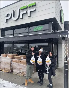  ?? PHOTO COURTESY OF PUFF CANNABIS ?? Representa­tives from Puff Cannabis dispensary in Utica show off some of the turkeys that were given away for Thanksgivi­ng.