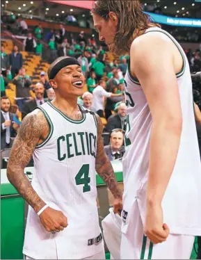  ?? ELSA / AGENCE FRANCE-PRESSE ?? Isaiah Thomas (left) and Kelly Olynyk of the Boston Celtics savor the moment after Monday’s 115105 win over the Washington Wizards in Game 7 of their NBA Eastern Conference semifinal at TD Garden in Boston, Massachuse­tts.