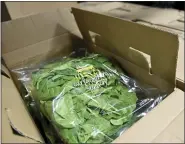  ??  ?? A box with bags of Wegmans curly cooking spinach in the refrigerat­or in the warehouse at Helping Harvest. At the Berks / Schuylkill Helping Harvest Fresh Food Bank in Spring Township Wednesday morning January 20, 2021 where Claire Babineaux-Fontenot, the CEO of Feeding America. Helping Harvest is a member of Feeding America.