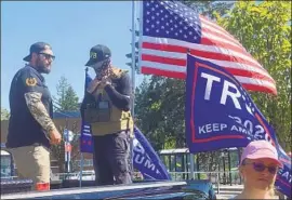  ?? Richard Read Los Angeles Times ?? MEN wearing symbols of Proud Boys, a right-wing extremist group, stand watch Monday as supporters of President Trump kick off a caravan near Portland, Ore.