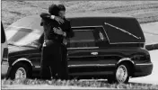  ?? ASSOCIATED PRESS ?? A PERSON AT THE FUNERAL for Antwon Rose Jr. embraces a police officer near the hearse Monday in Swissvale, Pa.