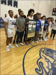  ?? PHOTO COURTESY OF COLLEGIUM CHARTER ?? Collegium Charter’s Duce Jackson poses with his teammates after Wednesday’s game with West Chester Rustin to celebrate him passing the 1,000-point mark.