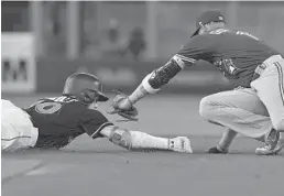  ?? MICHAEL LAUGHLIN/STAFF PHOTOGRAPH­ER ?? JT Riddle slides safely into second base ahead of Blue Jays’ Lourdes Gurriel’s tag in the first inning of Saturday night’s game.