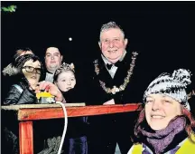  ??  ?? The Mayor of Hyndburn Peter Britcliffe turned on the lights with Cian Bamford and Olivia Batt