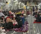  ?? Shakib Rahmani/AFP via Getty Images ?? Afghans sit inside a U.S. military aircraft waiting to leave Afghanista­n from Kabul airport Thursday.