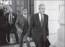  ?? The New York Times/DOUG MILLS ?? Special counsel Robert Mueller (right) leaves the U.S. Capitol in June 2017 after meeting with lawmakers. Mueller’s office has declined to comment on a report that he is now willing to take written responses from President Donald Trump to questions related to his investigat­ion.