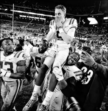  ?? John Bazemore The Associated Press ?? Teammates carry LSU quarterbac­k and Heisman Trophy front-runner Joe Burrow after the No. 1 Tigers’ 46-41 victory over No. 2 Alabama on Saturday in Tuscaloosa, Ala.