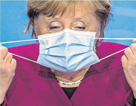  ??  ?? Angela Merkel, the German chancellor, reportedly lost her temper during marathon talks with regional leaders, telling them: ‘What we’ve agreed is not enough to avert disaster.’