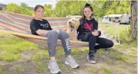  ?? PHOTO: GREGOR RICHARDSON ?? Just chilling . . . Sidnee Black (11, left), of Timaru, and Sophie Jonathan (11), of Dunedin, hang out on a hammock with Rusty the dog at the Waitangi Recreation Reserve at Lake Aviemore on Wednesday last week.
