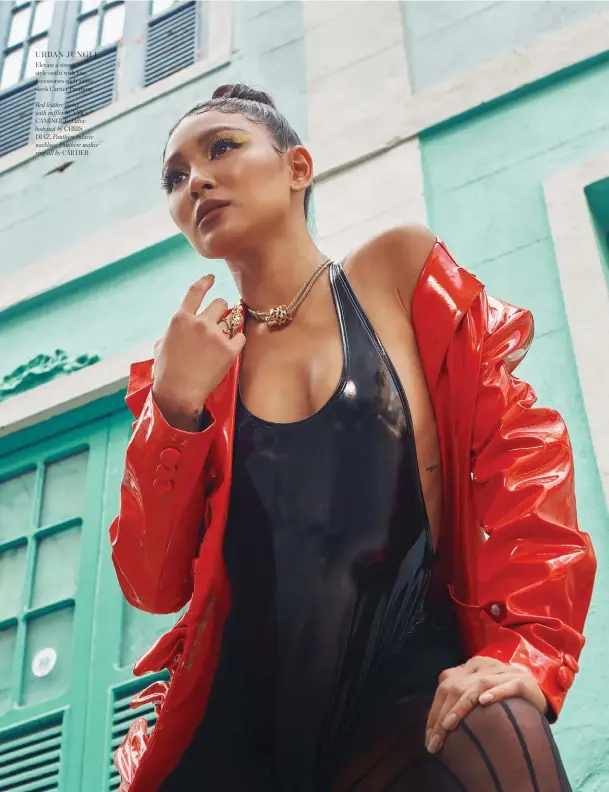  ??  ?? URBAN JUNGLE
Elevate a street style outfit with luxe accessorie­s such as the sleek Cartier Panthère
Red leather jacket with ruffles by YVES CAMINGUE, Latex bodysuit by CHRIS DIAZ, Panthère enlacèe nacklace, Panthère malice ring all by CARTIER