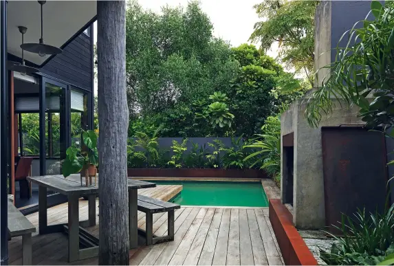  ??  ?? THIS PAGE The pillar in the outdoor area came from an old wharf and works well with the weathered look of the concrete and corten steel; plants around the pool include parlour palms, Cordyline stricta ‘Showoff’ and Australia umbrella trees. OPPOSITE (from left) An Artichoke pendant light by Louis Poulsen from ECC hangs over the entrance and the hallway that leads to the bedrooms and Kim’s office. The wall behind Kim and Jonathan’s bed has been painted a deep charcoal to work with the colours of the ensuite; the artwork above the bed is an original Indian miniature from Udaipur, painted on silk.