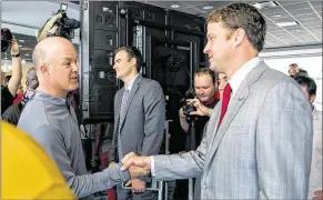  ?? RICHARD GRAULICH / THE PALM BEACH POST ?? Lane Kiffin, the new head football coach at FAU, shakes hands with Seminole Ridge football coach James Parson at FAU Stadium in Boca Raton.