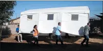  ?? KARL MONDON —STAFF ARCHIVES ?? In this Sept. 17, 2018, file photo, volunteers move the community tent of the Hope Village homeless encampment to a new temporary location on Ruff Drive at the offices of the SEIU local.