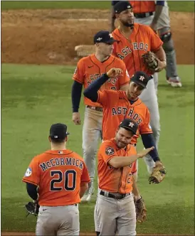  ?? TONY GUTIERREZ — THE ASSOCIATED PRESS ?? The Astros' Chas McCormick and Jose Altuve, right, celebrate with teammates after Houston beat the Rangers 10-3at Arlington, Texas, to tie the ALCS at two games apiece.