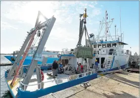  ?? SEAN D. ELLIOT/THE DAY ?? Researcher­s and crew of the University of Connecticu­t’s research vessel R/V Connecticu­t load scientific equipment Monday at Avery Point in Groton.