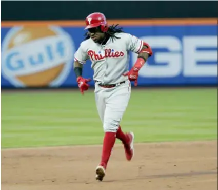  ?? FRANK FRANKLIN II — THE ASSOCIATED PRESS ?? Phillies third baseman Maikel Franco gestures to his teammates as rounds the bases after hitting a threerun homer Tuesday night. Franco has found a home hitting eighth in the lineup.