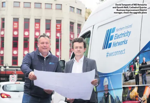  ??  ?? David Tompsett of NIE Networks and Gareth Neill, Cathedral Quarter
Business Improvemen­t District manager, check the upgrade plans