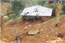  ??  ?? Security forces search for bodies from the scene of heavy flooding and mudslides in Regent, just outside of Sierra Leone’s capital, Freetown, on Tuesday,