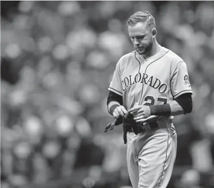  ?? Dylan Buell, Getty Images ?? Colorado’s Trevor Story walks off the field after striking out in the eighth inning of Game 2 of the NLDS against the Milwaukee Brewers at Miller Park on Friday. In the NLDS, Story is 0for8 with five strikeouts.