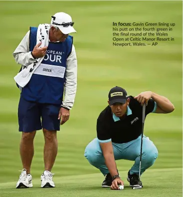  ?? — AP ?? In focus: Gavin Green lining up his putt on the fourth green in the final round of the Wales Open at Celtic Manor Resort in Newport, Wales.