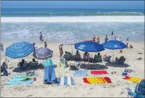  ?? MARK RIGHTMIRE STAFF PHOTOGRAPH­ER ?? Be careful picking your spot on the sand for the Forth of July. A high tide at 6 p.m. means a shrinking beach during the day. Big surf and rip currents may also pose hazards.