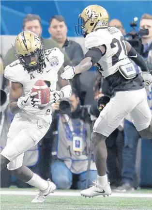  ?? MIKE STEWART/AP ?? UCF cornerback Brandon Moore, right, shown here in the Peach Bowl: “I think our receiving corps will probably be the best guys we play against, so it’s always good going against those guys every day.”