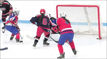  ?? Photo by Ernest A. Brown ?? Cumberland freshman forward Sara DeSousa, left, scores the first of her three goals in Friday night’s 4-2 Division I playoff win over No. 6 Warwick at Adelard Arena. The No. 3 Mounties can finish the series sweep tonight at Thayer Arena.