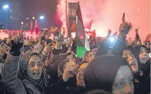  ?? Picture: Getty Images. ?? Protesters wave flags and shout slogans outside the US Consulate in Istanbul, Turkey, after Mr Trump’s speech.