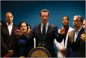  ?? RANDY VAZQUEZ — BAY AREA NEWS GROUP ?? Governor Gavin Newsom, center, speaks to members of the media regarding to Grand Princess cruise ship at Elihu M. Harris State Office Building in Oakland on March 8.