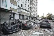  ?? ALEX BABENKO / AP ?? Damaged cars are parked in the yard of a multi-story apartment building which was damaged in a relentless wave of bombardmen­ts targeting in Kyiv, Ukraine, Tuesday.