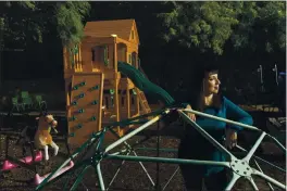  ?? DAMIAN DOVARGANES — THE ASSOCIATED PRESS ?? Mary De La Rosa stands inside a play structure in her backyard, that once housed the child care program, Creative Explorers, in Los Angeles.