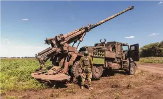  ?? David Guttenfeld­er/New York Times ?? A Ukrainian soldier mans an artillery unit Thursday in Zaporizhzh­ia region. U.S. officials and military analysts say cluster munitions may not have an immediate impact on the war.