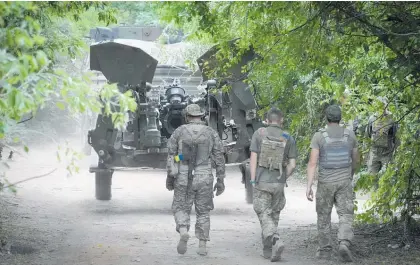  ?? Photo / AP ?? Ukrainian soldiers move a Us-supplied howitzer to fire at Russian positions in the eastern Donbas region.