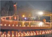 ?? AFP ?? Residents light candles to commemorat­e the victims of the 1932-33 Holodomor, Ukrainian for ‘death by starvation’, in Lviv amid the Russian invasion of Ukraine, on Saturday.