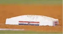  ?? DAVID ZALUBOWSKI/ASSOCIATED PRESS ?? Special plaques to commemorat­e the anniversar­y of the Sept. 11, 2001, terrorist attacks mark the bases, as seen during Tuesday’s game between the Rockies and Diamondbac­ks in Denver.