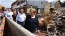  ??  ?? Merkel visited flood-stricken areas with her would-be successor as chancellor, Armin Laschet